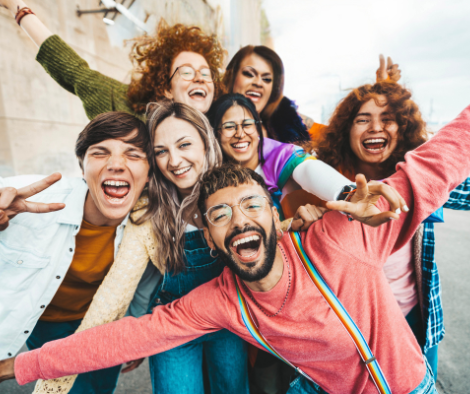 Group of friends celebrating life. Living as an LGBTQ+ person in today’s world still carries real psychological weight.